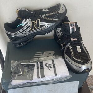 New Balance Black and Silver Sneakers come with Nike socks